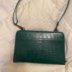 Calpak travel wallet on a chain